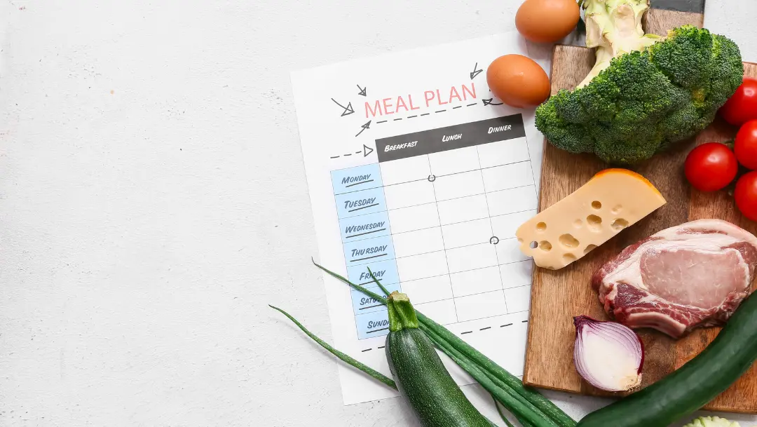 Overhead view of an organized weekly meal spread